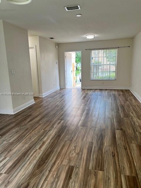 View of main living area to front door with view of entrance to half bath and garage
