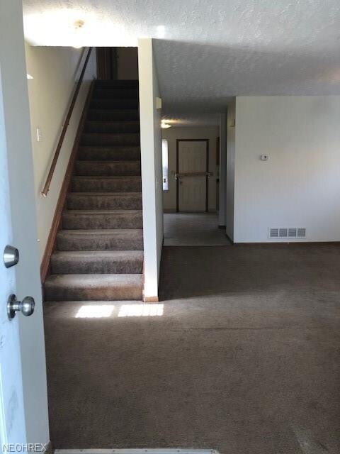 View of living room and steps to 2nd floor from fr