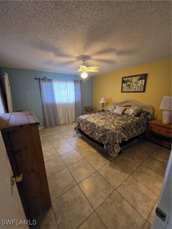Bedroom featuring light tile patterned flooring, a