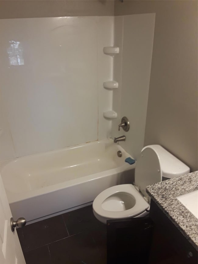 Full bathroom featuring vanity, tile patterned flo