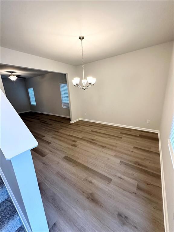 Unfurnished dining area with ceiling fan with nota