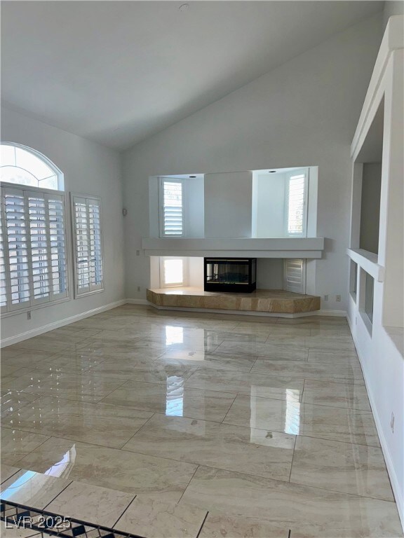 Unfurnished living room featuring marble tiled flo