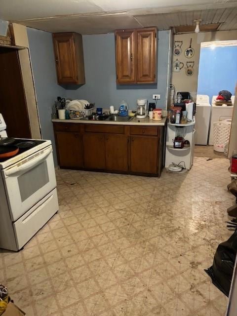 Kitchen with range, sink, and light tile patterned