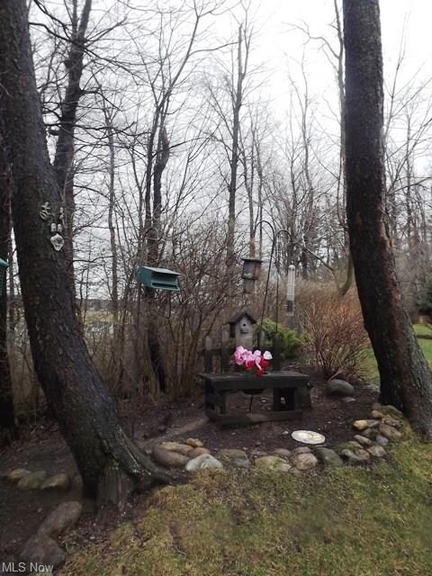 How cute is this landscaping, bordering the woods,