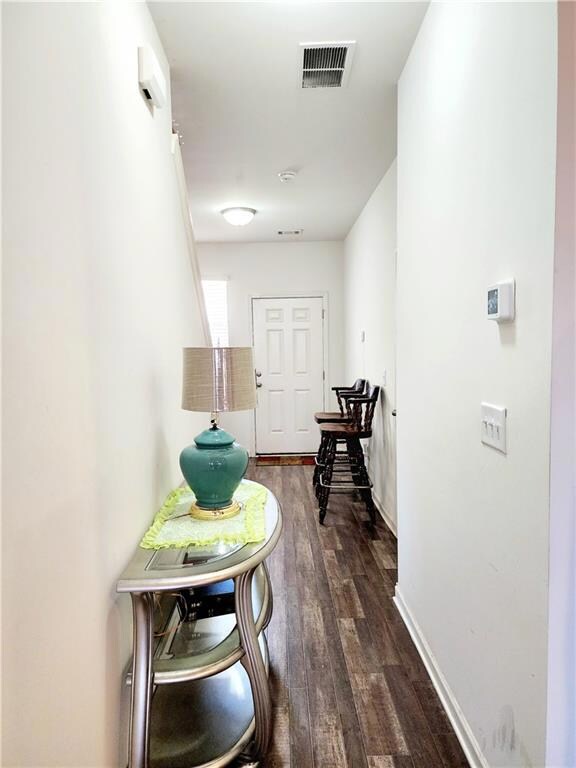 Corridor with baseboards, dark wood finished floor