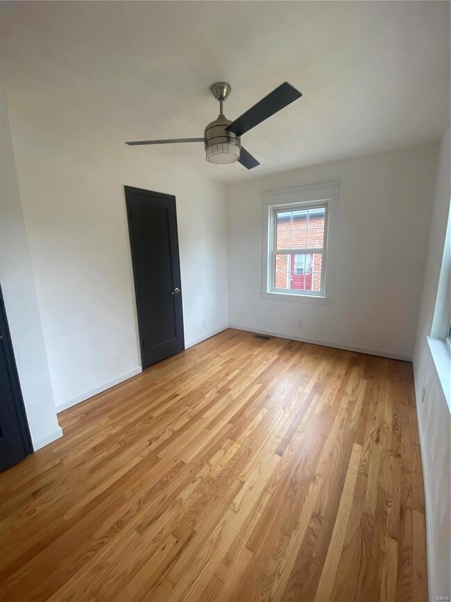 Rear bedroom, new fan, walls and refinished floors.