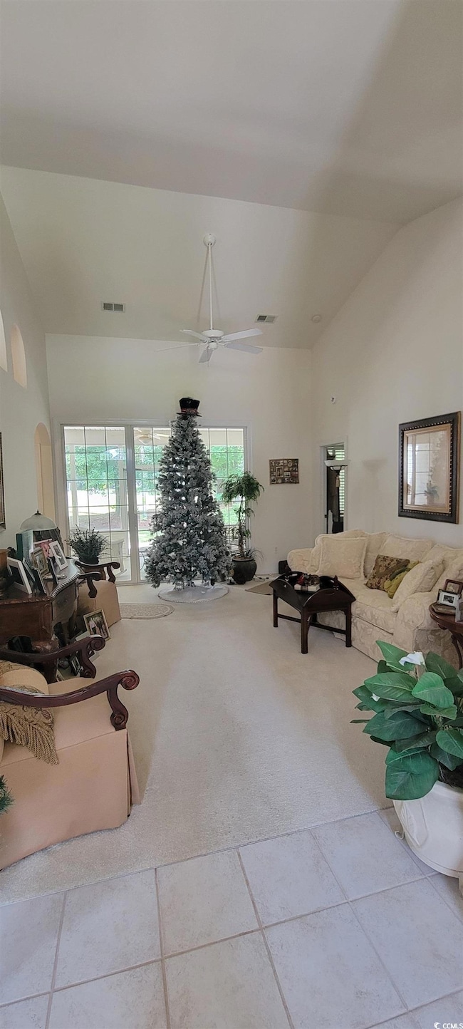 carpet flooring and a high ceiling