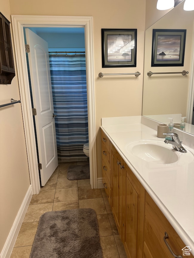Bathroom featuring vanity, a shower with curtain, and tile patterned floors