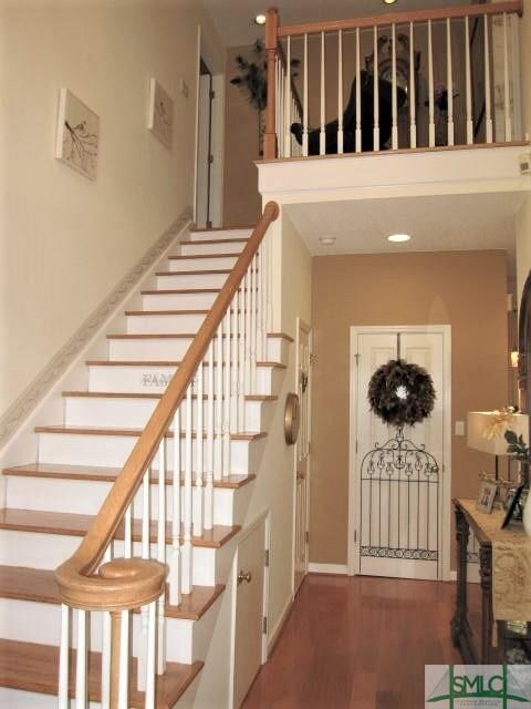 Elegant wood floors in the twp-story foyer.