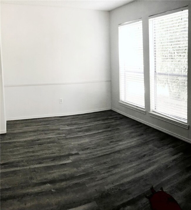 Unfurnished room with dark wood-type flooring