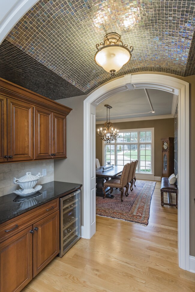 The Butler's pantry has an incredible, custom tiled barrel ceiling, granite counter-tops and wine refrigerator. There is ample storage for all your flatware and formal dining ware.