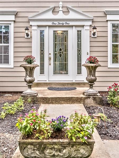 Welcome to the front porch with cement pots for yo