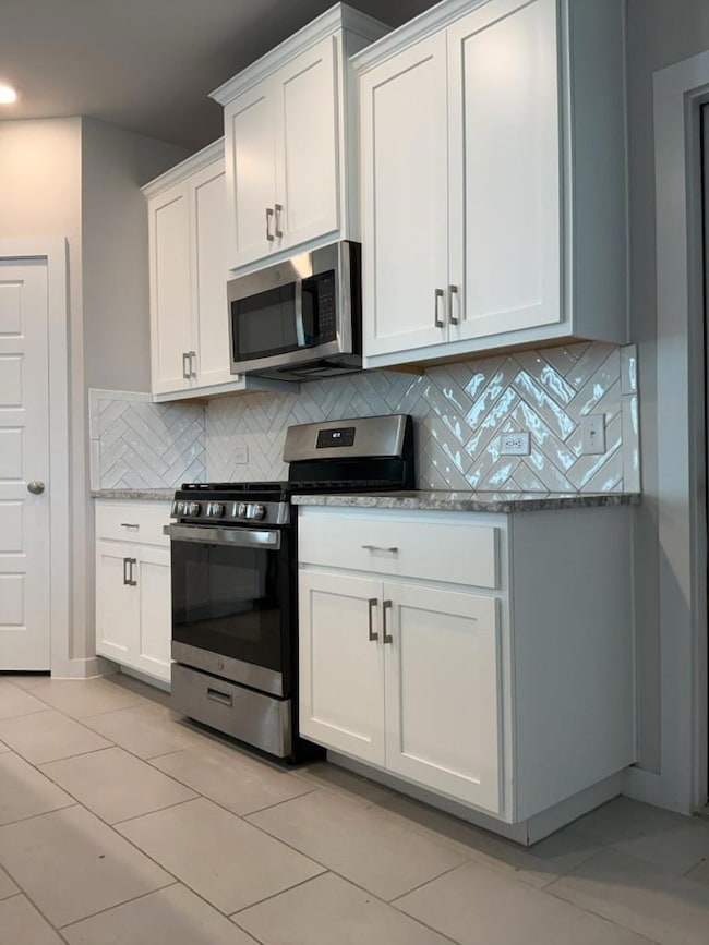 Kitchen with stainless steel appliances, tasteful