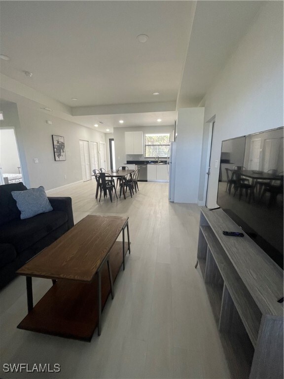 Living room with light hardwood / wood-style flooring
