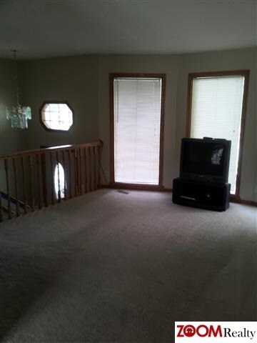 A beautiful open railing leads the way from the front entry into this lovely home.