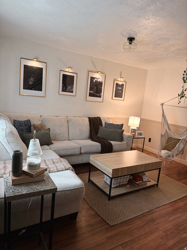 Living room featuring wood finished floors and a textured ceiling
