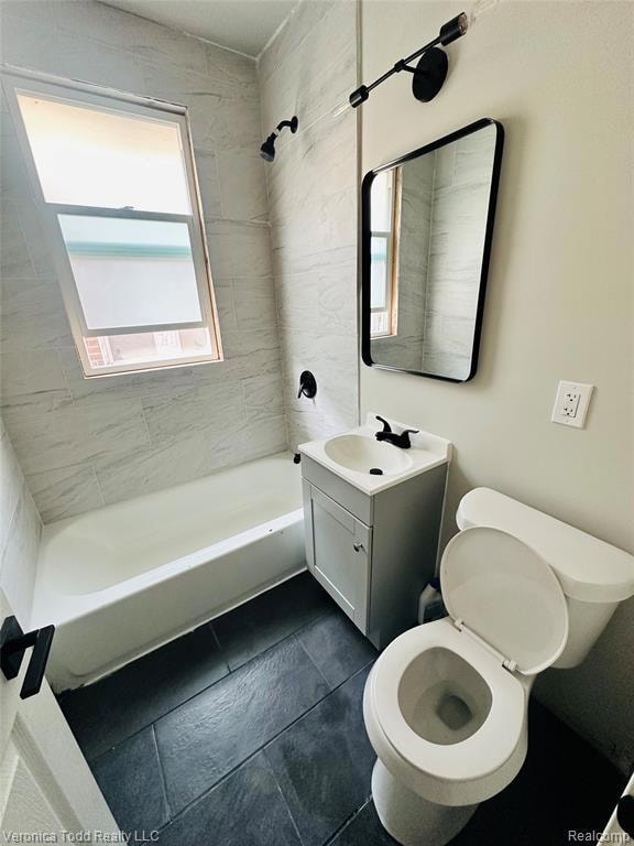 Full bath featuring vanity and washtub / shower combination