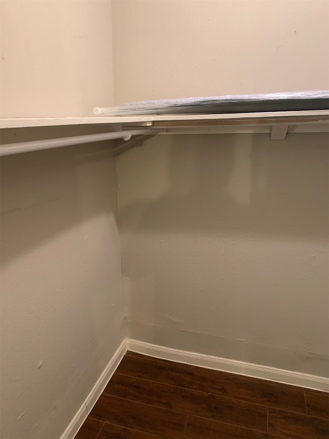 The photo shows a small, empty closet space with a