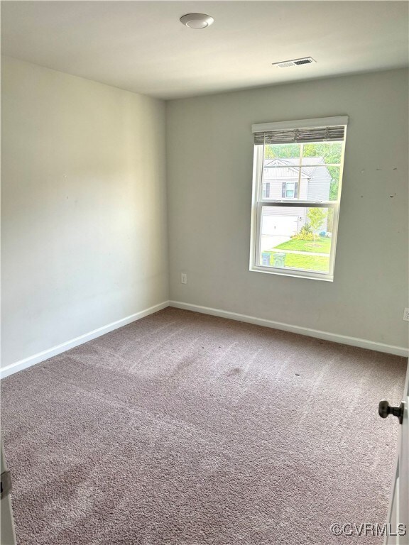 Unfurnished room with carpet flooring and baseboar