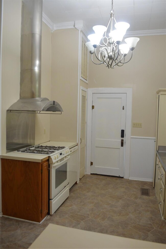 Kitchen featuring a notable chandelier, tile floor