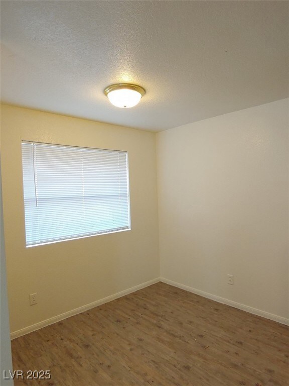 Unfurnished room featuring a textured ceiling and