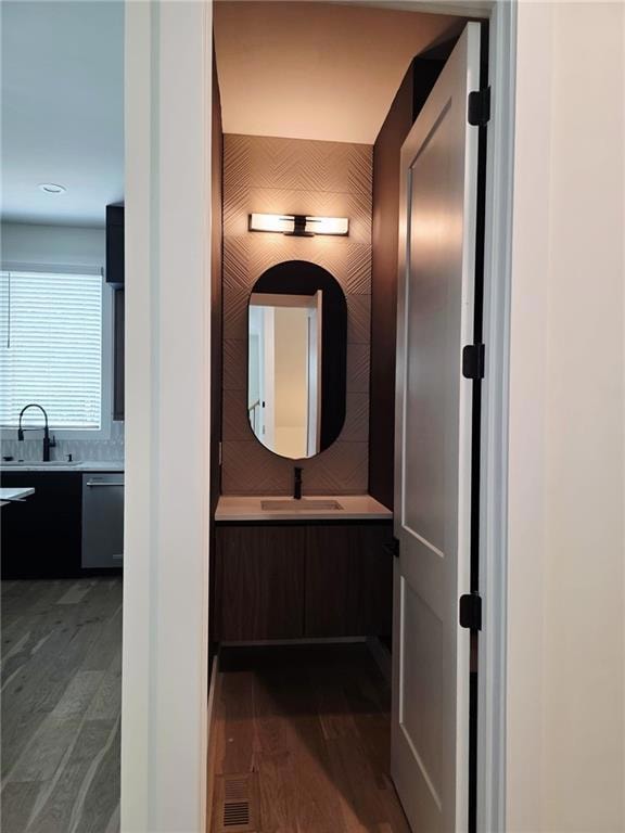 Bathroom featuring vanity and wood finished floors