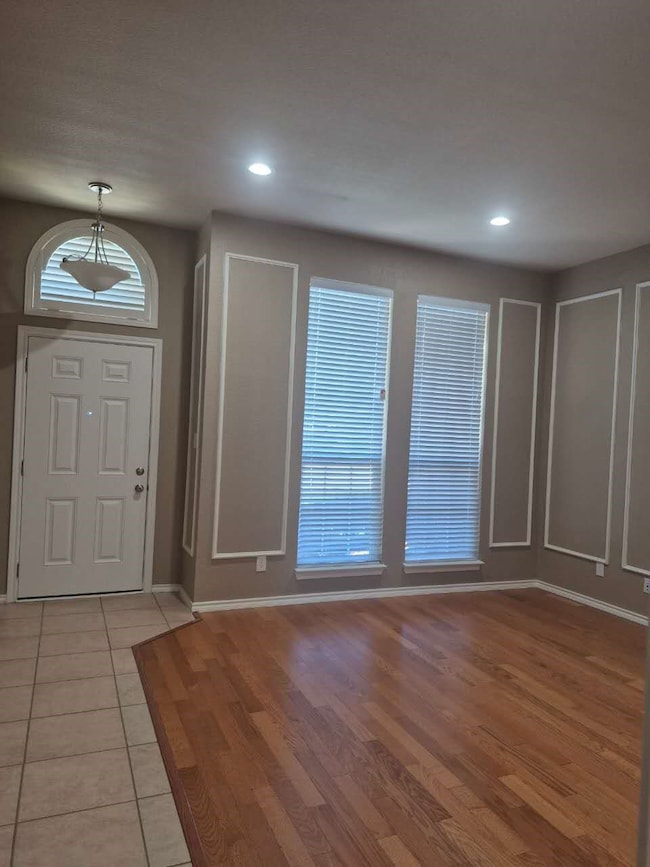 Entrance foyer with light wood-style floors and recessed lighting