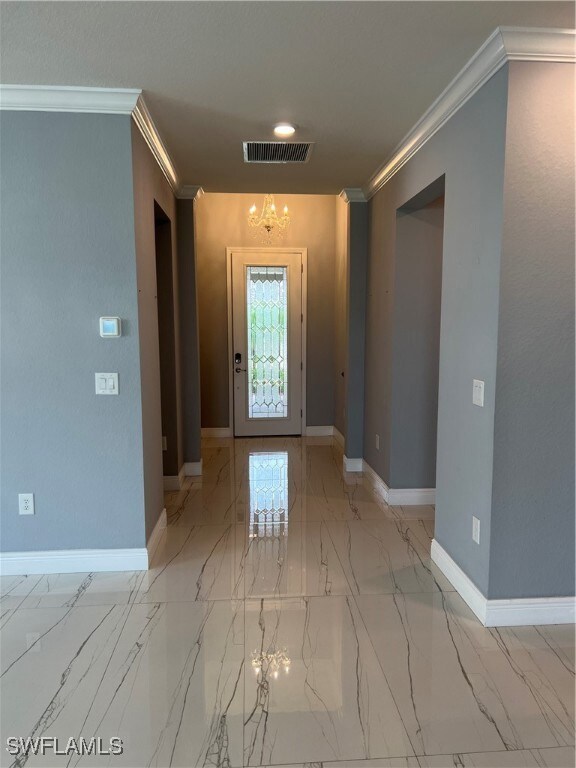 Foyer with marble finish floor, baseboards, visibl