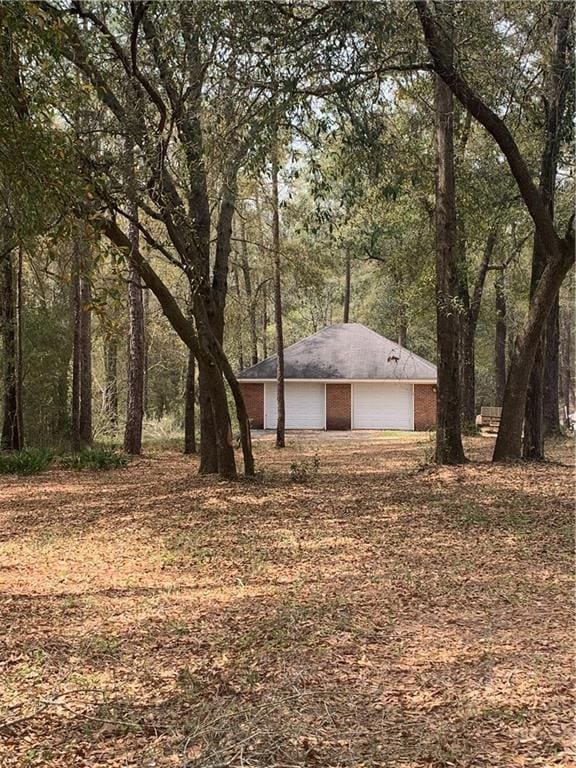 View of yard featuring a detached garage, a view o