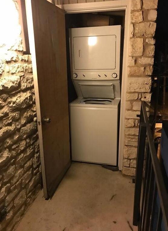 Washroom with stacked washing maching and dryer a