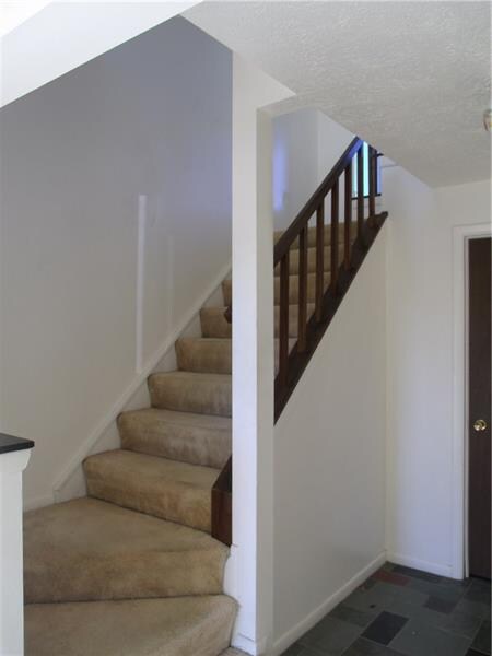 Spacious foyer with large laundry room and storage