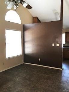 Kitchen featuring dark countertops and lofted ceiling