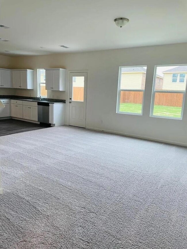 Unfurnished living room featuring carpet flooring