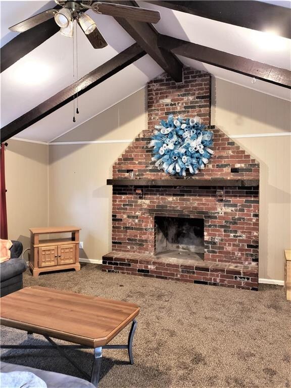 VAULTED AND BEAMED CEILING WITH CEILING FAN.