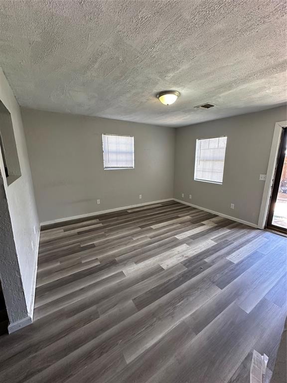 Empty room featuring wood finished floors, plenty 