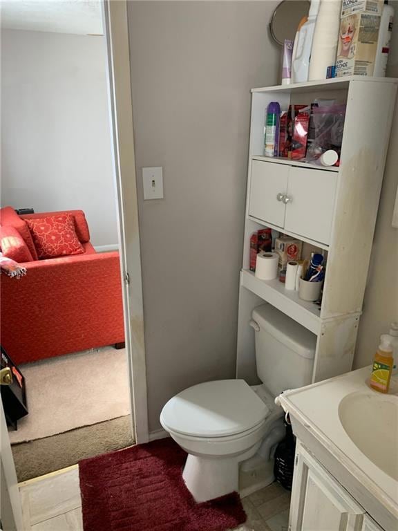 Half bathroom featuring vanity and toilet