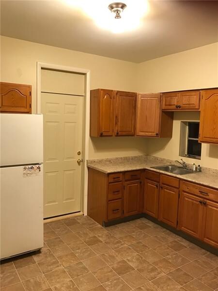 New large kitchen with new flooring and refrigerat