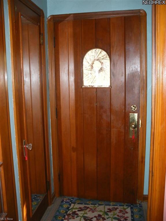 Foyer with Closet & bench. Gorgeous Wood doors