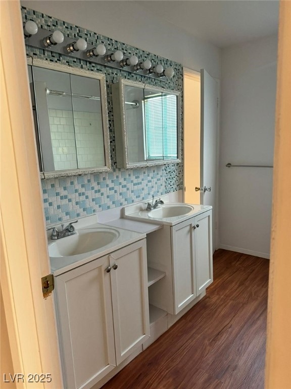 Bathroom with vanity, wood finished floors, decora