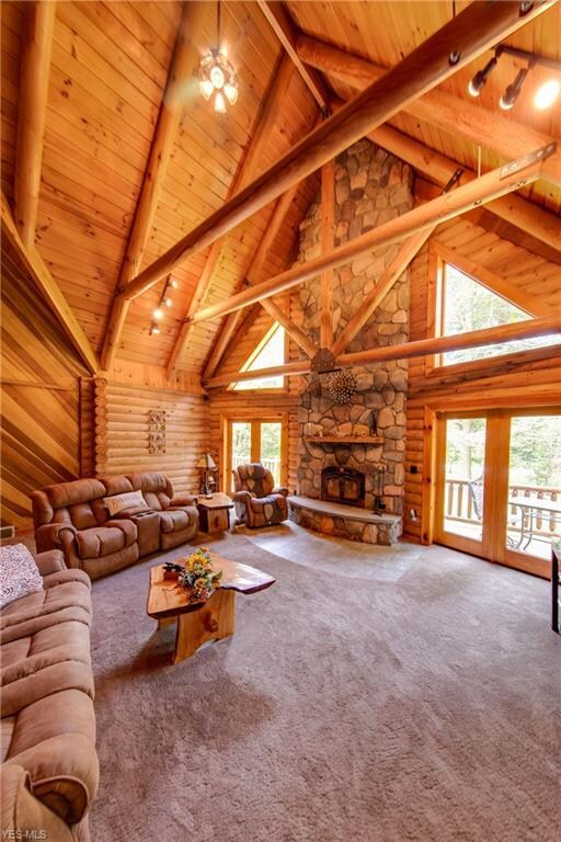This great room is soaring with ceilings, a stone fireplace and beams galore!