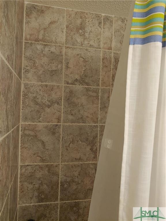 Hall bath--with tile shower wall over tub