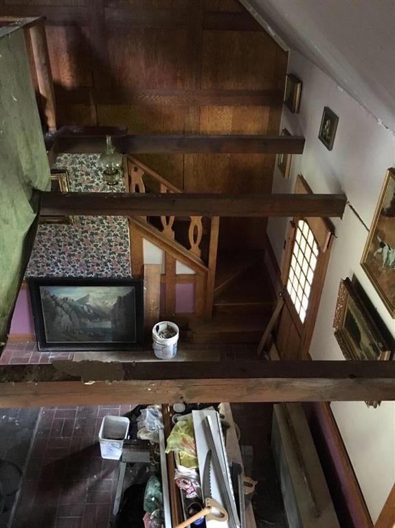 View from upstairs looking down on living room, towards hand crafted staircase and railing
