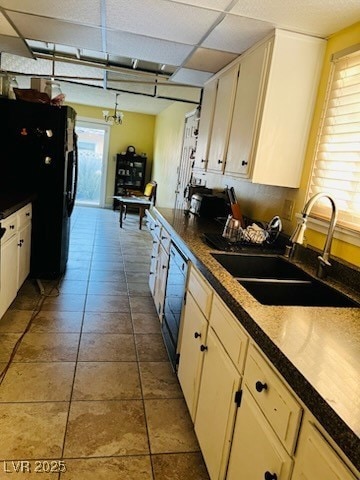 Kitchen with freestanding refrigerator, a sink, di