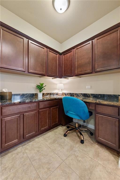 Office space with built in desk and light tile pa