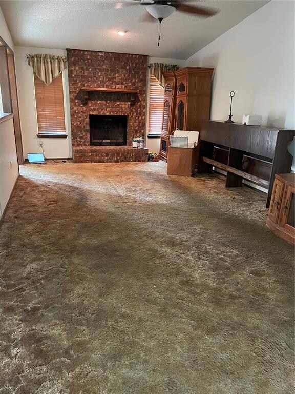 Carpeted living room featuring a textured ceiling,