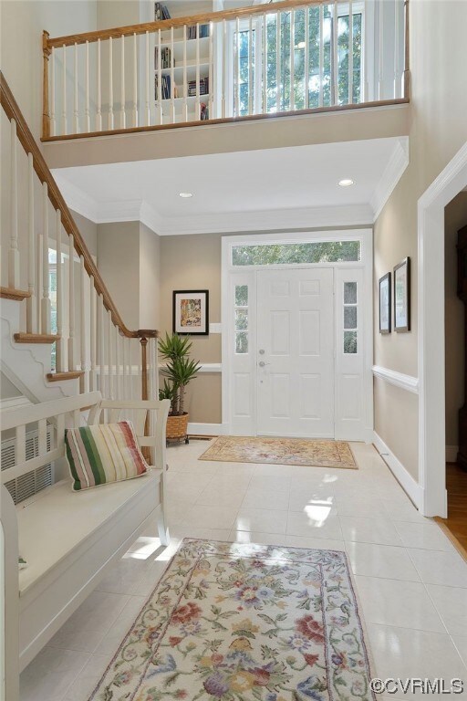 The catwalk above the foyer opens to the master be