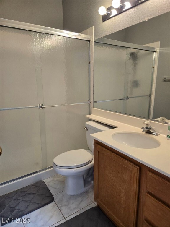 Bathroom featuring vanity and a shower stall