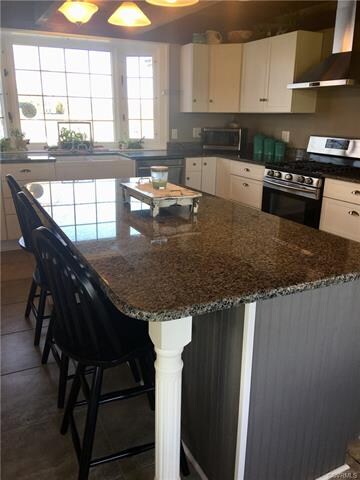 Kitchen has a huge island with seating and storage