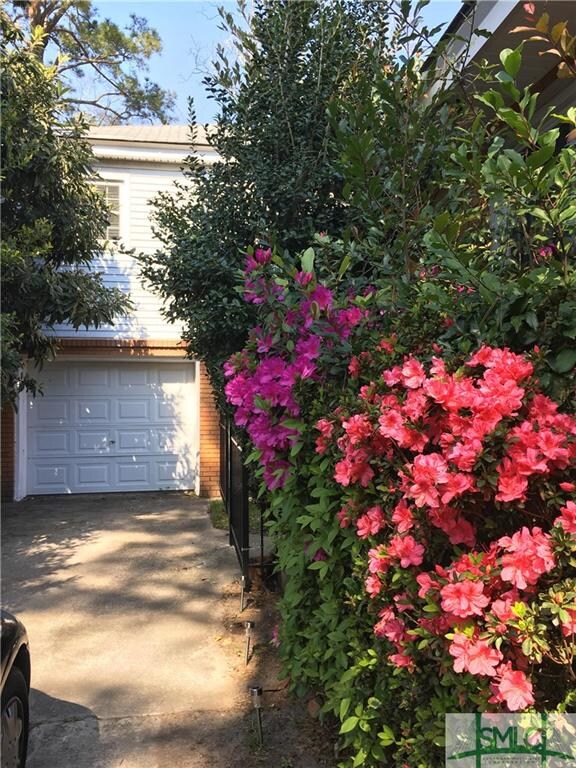 Spring blooms and a view of the garage and carriag