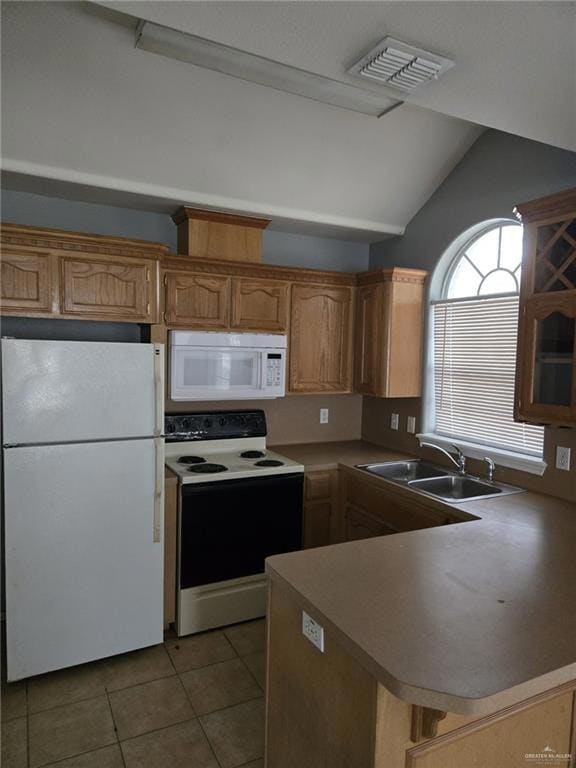 Kitchen with sink, kitchen peninsula, vaulted ceiling, white appliances, and light tile patterned flooring